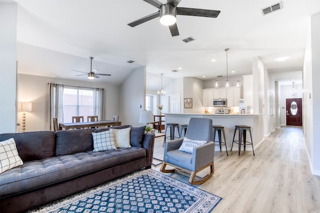 2836 Dawn Spring Dr, Little Elm, TX 75068 - living room with ceiling fan, light wood-style flooring, vaulted ceiling, and baseboards