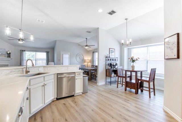 2836 Dawn Spring Dr, Little Elm, TX 75068 - kitchen with stainless steel dishwasher, a sink, a ceiling fan, vaulted ceiling, and light wood-style floors