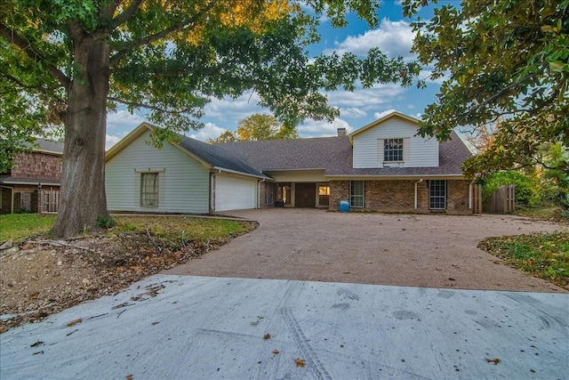 3417 Stewart Cir, Waco, TX 76708 - traditional home with a garage, driveway, brick siding, a shingled roof, and a chimney