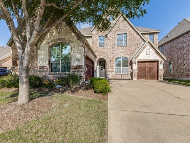 114 Crestbrook Dr, Rockwall, TX 75087 - view of front facade with brick siding, concrete driveway, and a shingled roof