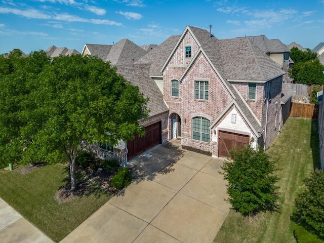 114 Crestbrook Dr, Rockwall, TX 75087 - view of front of house featuring concrete driveway, brick siding, stone siding, an attached garage, and a shingled roof