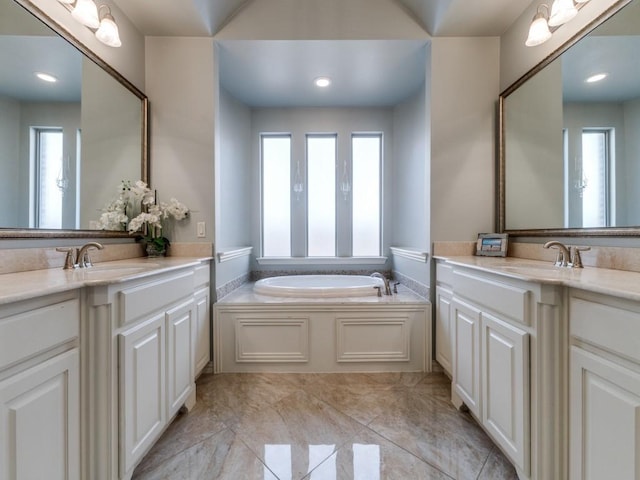 114 Crestbrook Dr, Rockwall, TX 75087 - bathroom featuring two vanities and a garden tub