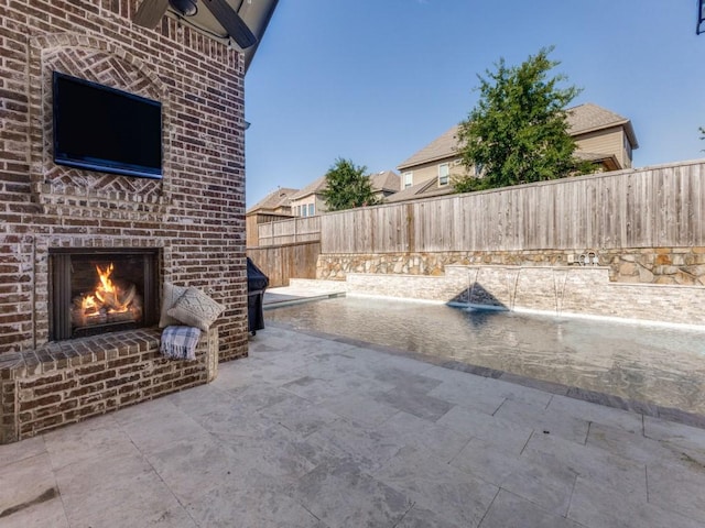 114 Crestbrook Dr, Rockwall, TX 75087 - fenced backyard featuring an outdoor brick fireplace and a patio area
