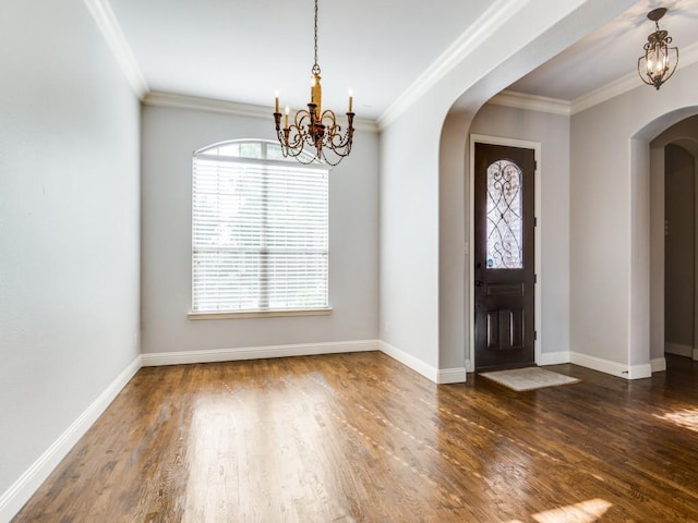 114 Crestbrook Dr, Rockwall, TX 75087 - entryway featuring arched walkways, a chandelier, wood finished floors, baseboards, and crown molding