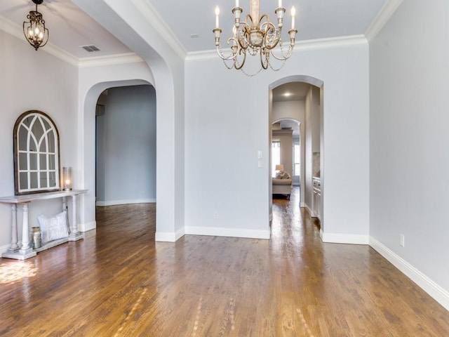 114 Crestbrook Dr, Rockwall, TX 75087 - spare room with wood finished floors, a chandelier, arched walkways, and ornamental molding