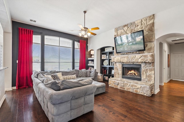 10601 Los Rios Dr, Fort Worth, TX 76179 - living area featuring a ceiling fan, arched walkways, a fireplace, a wall mounted AC, and hardwood / wood-style floors
