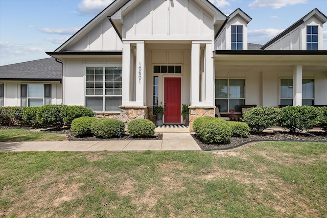 10601 Los Rios Dr, Fort Worth, TX 76179 - view of front facade featuring a porch, board and batten siding, a front yard, roof with shingles, and stone siding