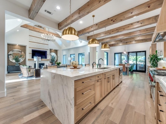 620 Redwood Creek Dr, Fairview, TX 75069 - kitchen with a sink, light brown cabinetry, beam ceiling, a spacious island, and light wood finished floors