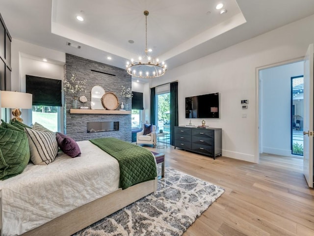 620 Redwood Creek Dr, Fairview, TX 75069 - bedroom with a tray ceiling, baseboards, light wood-type flooring, access to exterior, and a chandelier