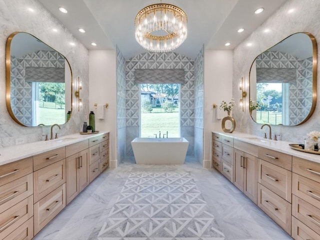 620 Redwood Creek Dr, Fairview, TX 75069 - bathroom featuring healthy amount of natural light, a chandelier, two vanities, and recessed lighting