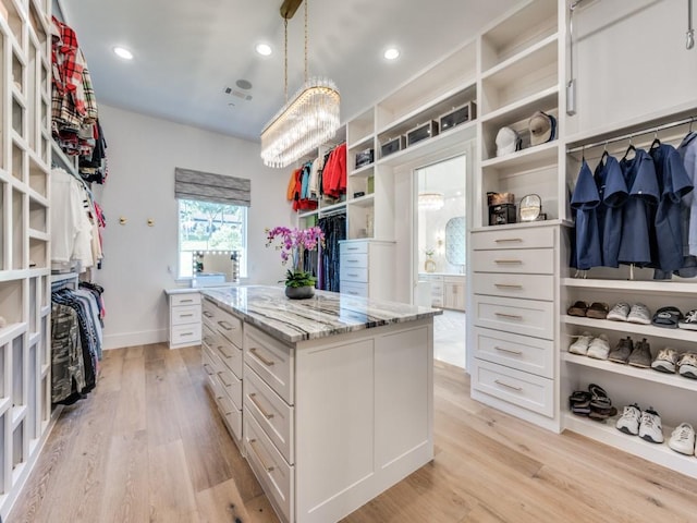 620 Redwood Creek Dr, Fairview, TX 75069 - walk in closet with light wood finished floors and a chandelier