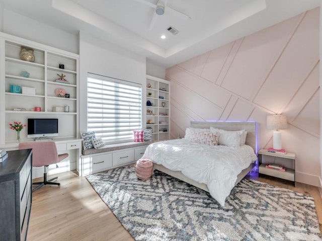 620 Redwood Creek Dr, Fairview, TX 75069 - bedroom with a raised ceiling, a desk, light wood finished floors, a decorative wall, and a ceiling fan