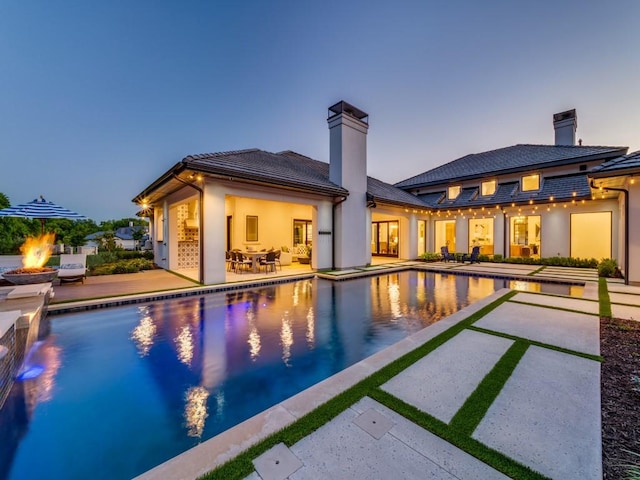 620 Redwood Creek Dr, Fairview, TX 75069 - pool at dusk with a patio area, an outdoor pool, and an outdoor fire pit