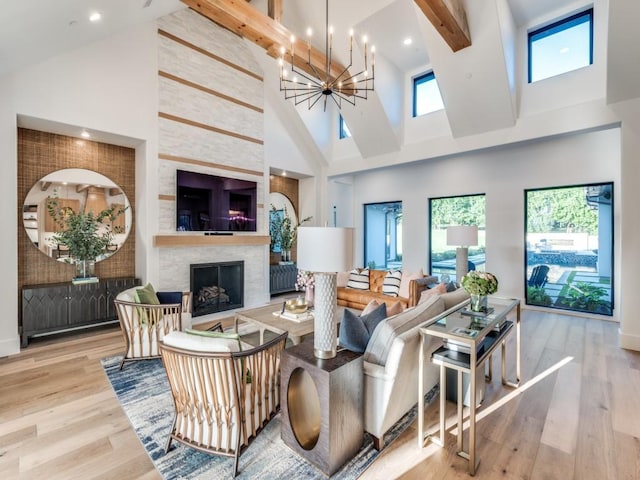 620 Redwood Creek Dr, Fairview, TX 75069 - living area featuring high vaulted ceiling, a chandelier, wood finished floors, a stone fireplace, and beam ceiling