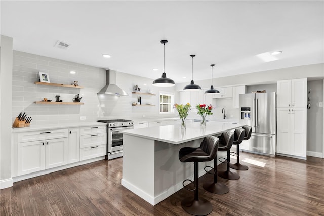 9031 Fringewood Dr, Dallas, TX 75228 - kitchen with appliances with stainless steel finishes, wall chimney range hood, open shelves, backsplash, and light countertops