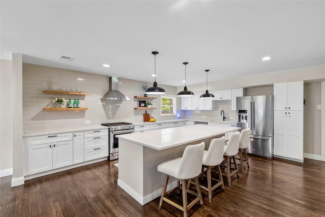 9031 Fringewood Dr, Dallas, TX 75228 - kitchen with high end appliances, wall chimney exhaust hood, open shelves, tasteful backsplash, and a kitchen island