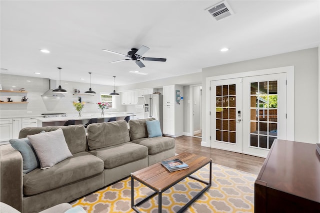 9031 Fringewood Dr, Dallas, TX 75228 - living area with recessed lighting, french doors, light wood-type flooring, a ceiling fan, and baseboards