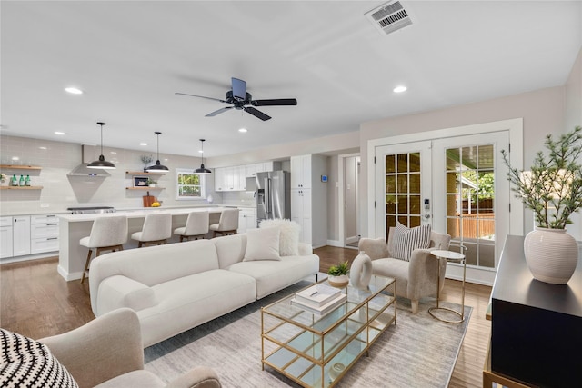9031 Fringewood Dr, Dallas, TX 75228 - living area featuring wood finished floors, french doors, ceiling fan, and recessed lighting