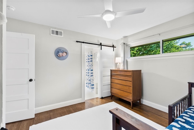 9031 Fringewood Dr, Dallas, TX 75228 - bedroom featuring a barn door, wood finished floors, and ceiling fan