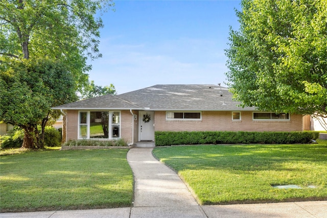 9031 Fringewood Dr, Dallas, TX 75228 - ranch-style house with brick siding, a front yard, and roof with shingles