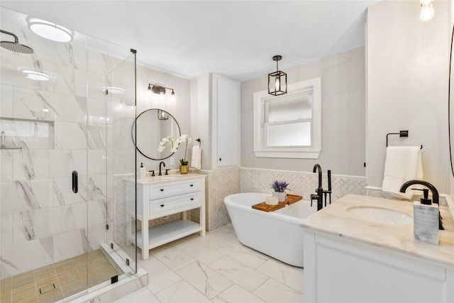 9031 Fringewood Dr, Dallas, TX 75228 - bathroom with a shower stall, two vanities, a freestanding bath, marble finish floors, and a wainscoted wall