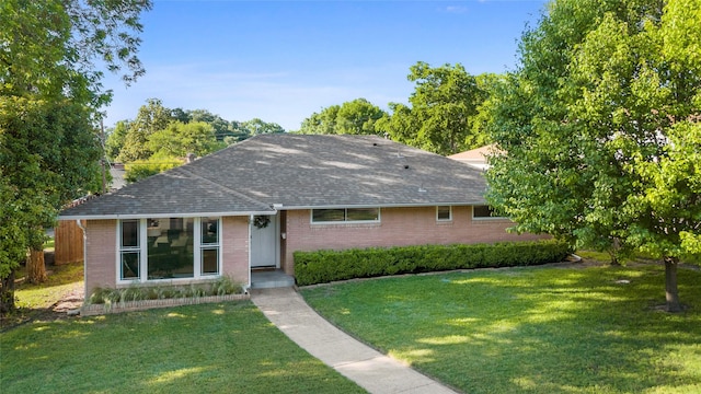 9031 Fringewood Dr, Dallas, TX 75228 - ranch-style home with brick siding, roof with shingles, and a front lawn