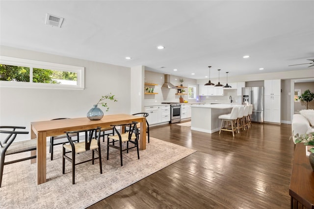 9031 Fringewood Dr, Dallas, TX 75228 - dining room with healthy amount of natural light, recessed lighting, dark wood-type flooring, and ceiling fan