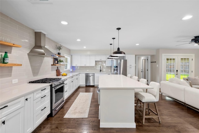 9031 Fringewood Dr, Dallas, TX 75228 - kitchen with premium appliances, open shelves, wall chimney exhaust hood, backsplash, and a kitchen bar