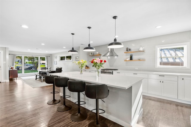 9031 Fringewood Dr, Dallas, TX 75228 - kitchen featuring decorative backsplash, gas stove, light wood-style floors, open shelves, and light countertops