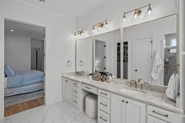 ensuite bathroom featuring double vanity, marble finish floors, ornamental molding, baseboards, and a tile shower