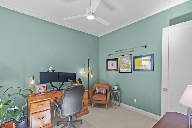 carpeted office space with ceiling fan, ornamental molding, and baseboards