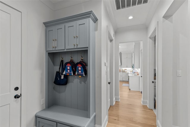 mudroom featuring light wood-type flooring, recessed lighting, and baseboards