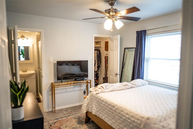 710 Melrose Dr, Richardson, TX 75080 - bedroom with a walk in closet, ensuite bathroom, a ceiling fan, and a closet