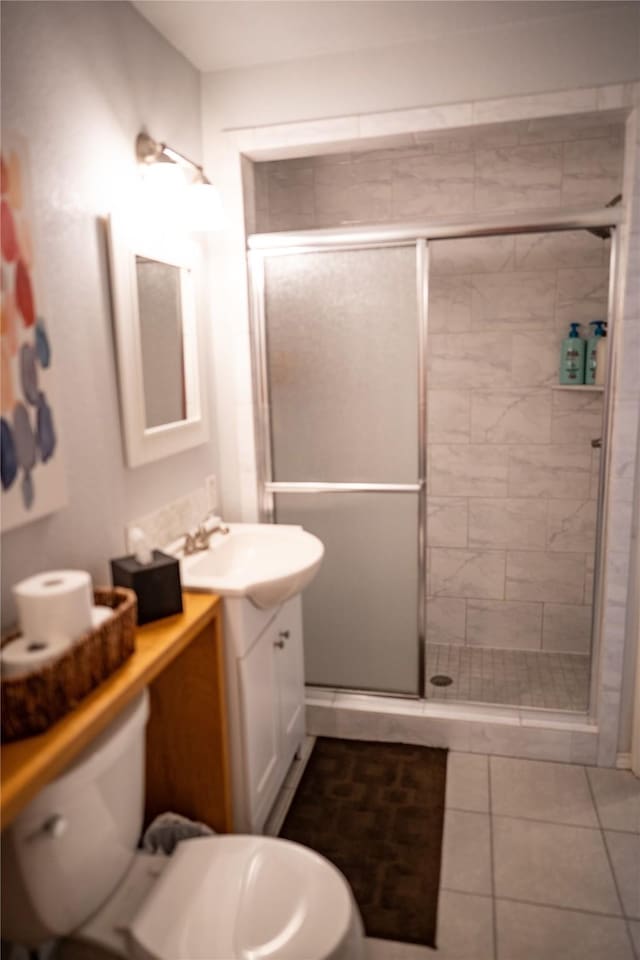 710 Melrose Dr, Richardson, TX 75080 - bathroom with a stall shower, toilet, vanity, and tile patterned floors
