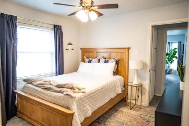 710 Melrose Dr, Richardson, TX 75080 - bedroom with multiple windows, a ceiling fan, and light carpet