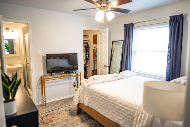 710 Melrose Dr, Richardson, TX 75080 - carpeted bedroom with ceiling fan, ensuite bath, a walk in closet, and baseboards