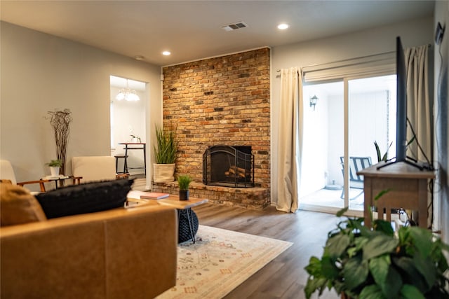 710 Melrose Dr, Richardson, TX 75080 - living area with a fireplace, wood finished floors, recessed lighting, and a chandelier