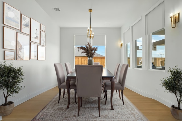 14524 Capridge Rd, Aledo, TX 76008 - dining area with light wood-type flooring, baseboards, and a chandelier