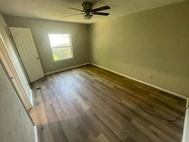 236 Ezekial Ave, Dallas, TX 75217 - unfurnished bedroom featuring wood finished floors, baseboards, a textured ceiling, and a ceiling fan