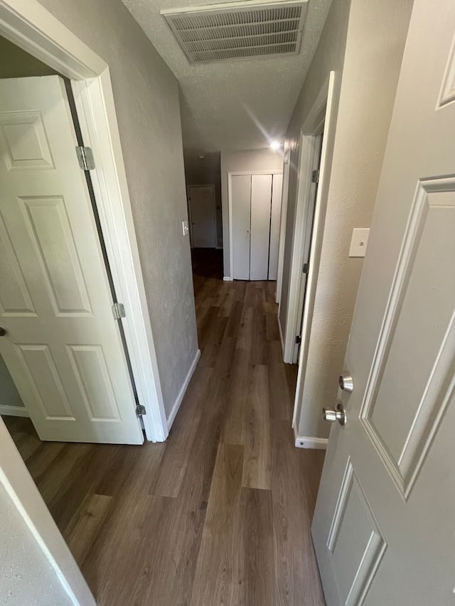 236 Ezekial Ave, Dallas, TX 75217 - hall with dark wood finished floors, baseboards, and a textured wall