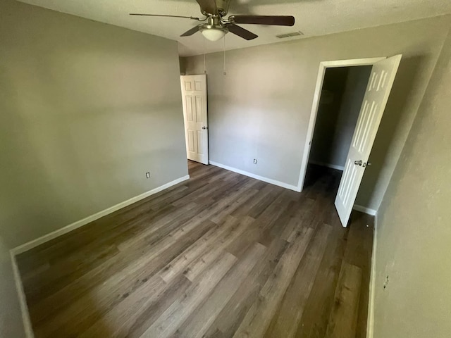 236 Ezekial Ave, Dallas, TX 75217 - unfurnished bedroom with dark wood-type flooring, baseboards, and a ceiling fan
