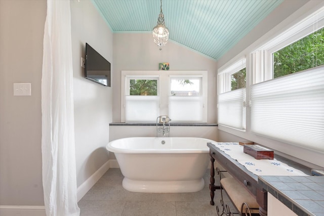 404 E Wall St, Grapevine, TX 76051 - full bathroom with baseboards, a soaking tub, a chandelier, tile patterned floors, and vaulted ceiling