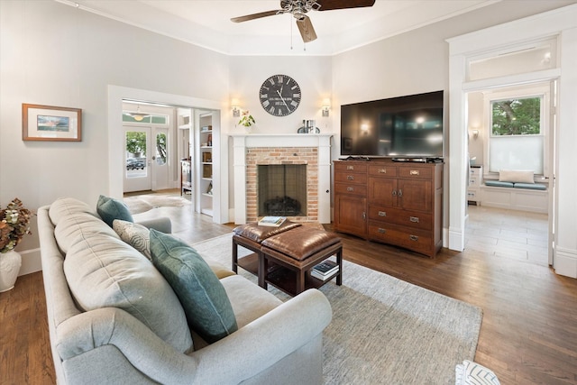 404 E Wall St, Grapevine, TX 76051 - living area featuring a ceiling fan, dark wood-style floors, a fireplace, ornamental molding, and baseboards