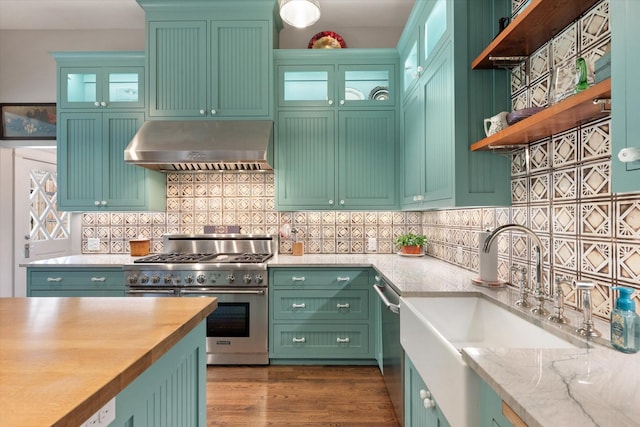404 E Wall St, Grapevine, TX 76051 - kitchen featuring appliances with stainless steel finishes, range hood, open shelves, a sink, and decorative backsplash