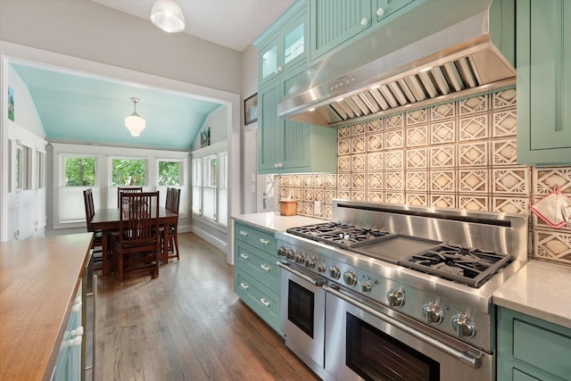 404 E Wall St, Grapevine, TX 76051 - kitchen with green cabinetry, range with two ovens, range hood, lofted ceiling, and backsplash