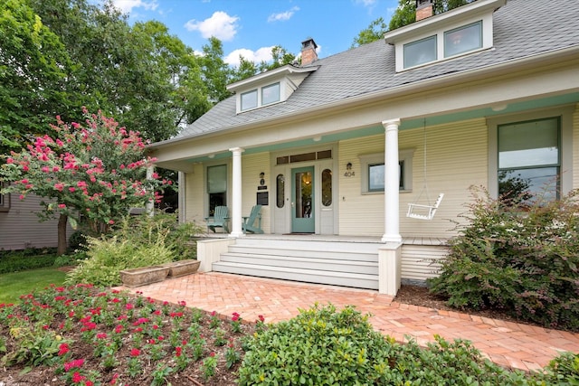 404 E Wall St, Grapevine, TX 76051 - view of front facade featuring a chimney and covered porch