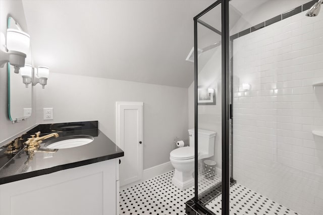404 E Wall St, Grapevine, TX 76051 - bathroom featuring double vanity, a shower stall, toilet, baseboards, and vaulted ceiling