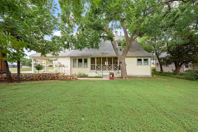 404 E Wall St, Grapevine, TX 76051 - rear view of house with a yard, a sunroom, an attached carport, a chimney, and a shingled roof