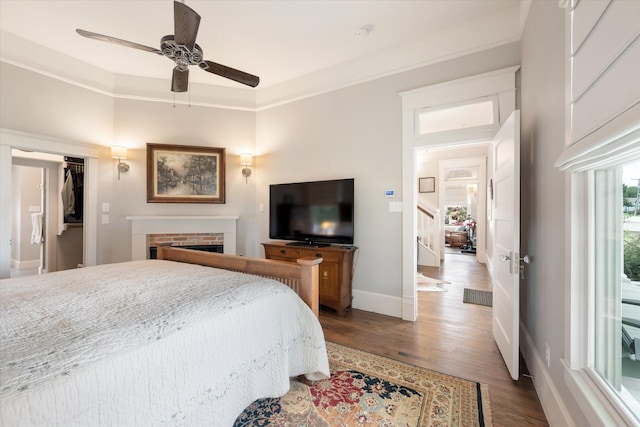 404 E Wall St, Grapevine, TX 76051 - bedroom with wood finished floors, a brick fireplace, baseboards, ornamental molding, and a ceiling fan