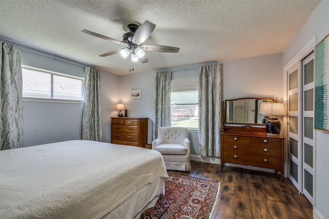 309 Westpark Dr N, Mckinney, TX 75071 - bedroom with multiple windows, wood finished floors, a textured ceiling, and a ceiling fan